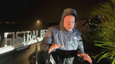 Presenter battles strong winds as Storm Austen hits Newquay