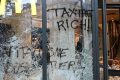 Burnt out cars and shattered glass on Paris streets after protests turn to riots and looting